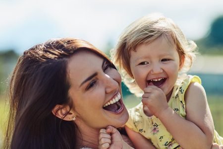 They share such a beautiful bond. a mother bonding with her little daughter outdoors.の写真素材