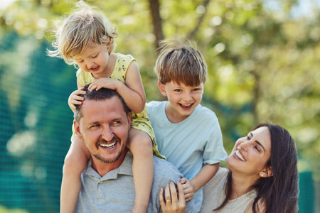 Our kids are always showered in unconditional love. a happy family bonding together outdoors.の写真素材