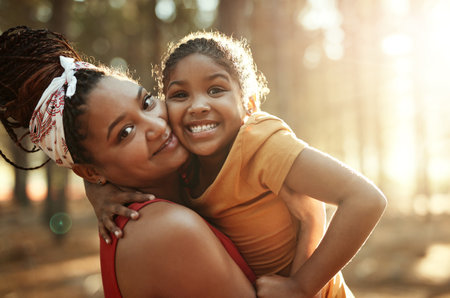 Its always fun with Mum. Portrait of a mother and her little daughter bonding in the woods.の写真素材