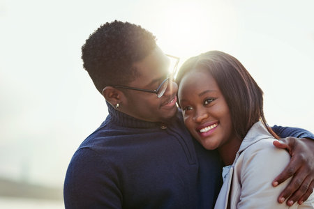 We belong together. an affectionate young couple bonding together outdoors.
