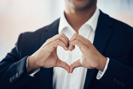 Businessman, hands and heart for love, thank you or symbol for message, icon or say for relationship. Romantic man with hand sign or voice in hearty shape emoji for loving, care or romance gestureの写真素材