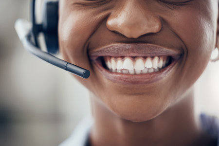 Black woman, teeth and smile with headset in call center, customer service or contact us at the office. Closeup of happy African American female consultant with toothy mouth smiling for telemarketingの写真素材