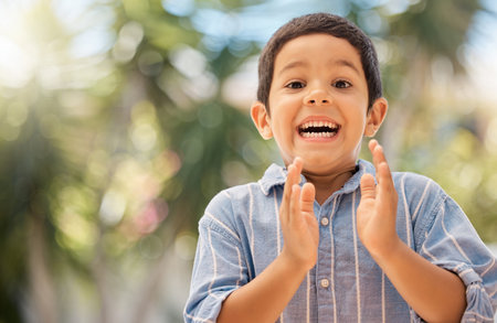 Happy, wow and boy clapping hands in in a park, excited and surprised by good news, nature and...