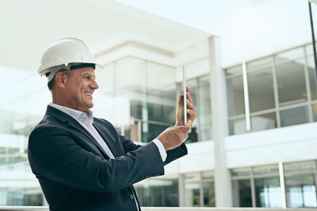 Just a quick photo to remember what needs attention. a cheerful professional male architect taking a...