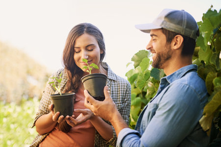 Farming is a profession of hope. two happy young farmers working together in the fields on their farm.の写真素材