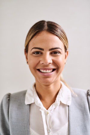 Young and ambitious. Portrait of an attractive young businesswoman standing in an office.の写真素材