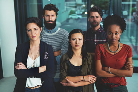 Standing tall as creative pioneers. Portrait of a group of diverse designers standing together in an...