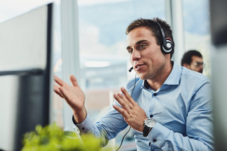 Handling calls with the utmost professionalism. a young call centre agent working in an office.