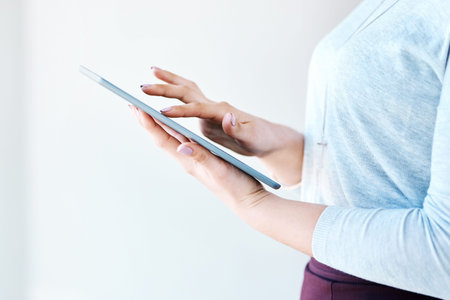 Expand your business into a new digital world. Closeup shot of an unidentifiable businesswoman using...