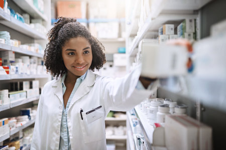 Ill explain everything you need to know about your medicine. an attractive young female pharmacist working in a pharmacy.の写真素材