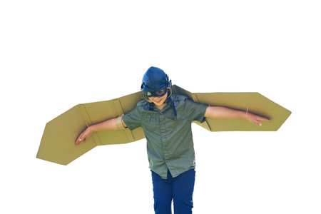 Go as far as your imagination takes you. a playful little boy pretending to be an airplane with a pair of cardboard wings.の写真素材