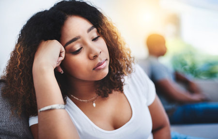 Theres always a chance to reconcile after conflict. a young woman looking despondent after having a fight with her partner at home.の写真素材