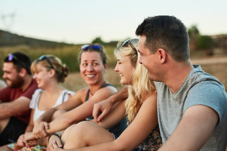 We all enjoy each others company. young people spending the day outside.の写真素材