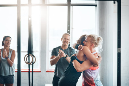Youll thank me later. a fitness group celebrating a victory at the gym.