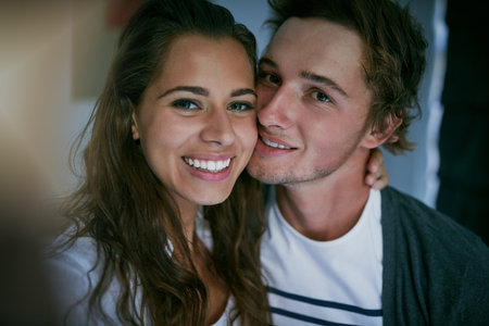 We couldnt be happier. an affectionate young couple at home.の写真素材