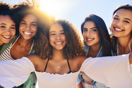 Summer memories are the best. a group of girlfriends posing for a selfie outdoors.の写真素材