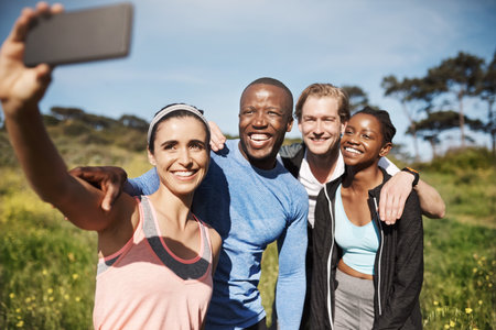This one will be my profile picture. a group of friends taking a selfie outdoors after their workout.の写真素材