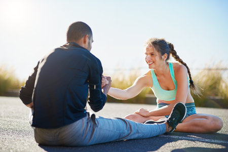 Helping each other gain a healthier lifestyle. a sporty young couple stretching before a run...