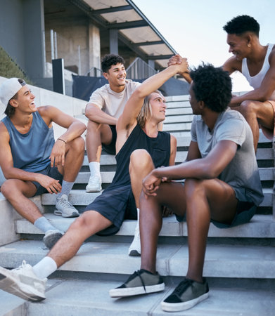 Friends, relax and group of men on building steps after training, exercise and workout in a city. Happy, handshake and sport man greeting guy, bonding and laughing, talking and fitness in New yorkの写真素材