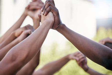 Diversity, holding hands and support with solidarity and prayer circle outdoor together. Group hands...