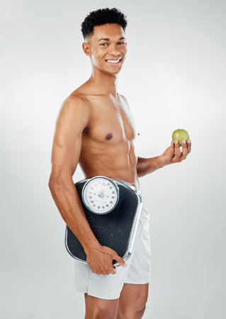 Weight loss, man health and body weight scale person happy about healthy living routine. Portrait of a fitness, exercise and wellness training workout athlete with happiness from muscles and dietの写真素材