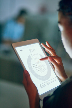 Checking out business stats. an unrecognizable businesswoman using a tablet at the office.の写真素材