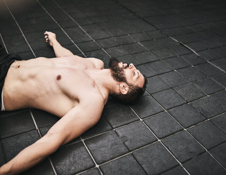 This is how I know it was a great workout. a young man taking a break from a workout in a gym.の写真素材