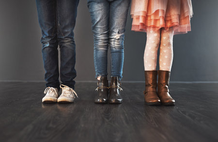 The coolest fashion for kids. Cropped studio shot of a group of kids standing against a gray wall.の写真素材