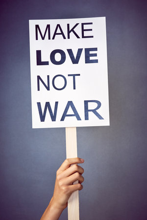 Stand up for what you believe in. an unidentifiable young woman holding up a poster with a message on it in studio.の写真素材