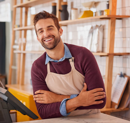 This is what job satisfaction looks like. Portrait of a happy business owner posing behind the counter in his coffee shop.の写真素材