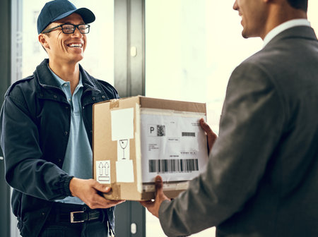 We specialise in fast and friendly delivery. a courier making a delivery to a customer.の写真素材