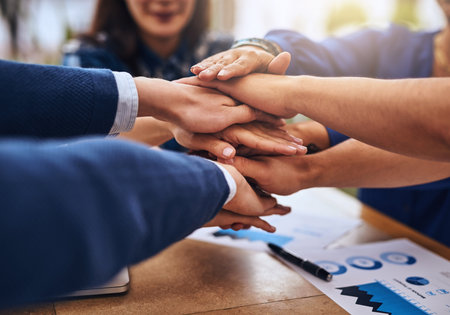 We have the magic to create. a group of unrecognisable peoples hands forming a huddle together...