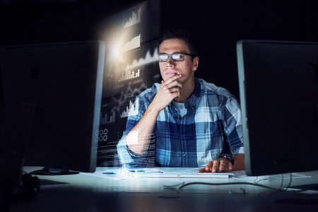 Carefully scouring through source code. a handsome young male programmer at work.の写真素材