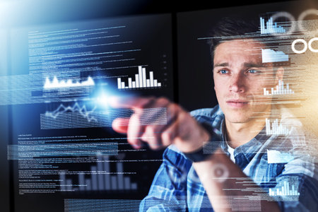 Touching the future. a handsome young male programmer at work.の写真素材