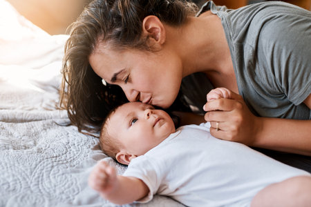 Nothing more true than a mothers love. a young woman bonding with her baby boy at home.の写真素材