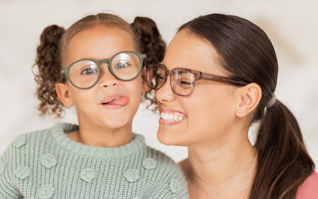 Family, glasses and happiness with mother and child happy with optics, eye care and lens frame choice for vision, focus and eyesight. Portrait of woman and comic girl with tongue for optical decisionの写真素材