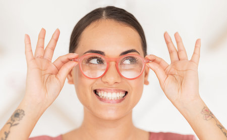 Vision, eyesight and woman putting on glasses with smile holding spectacles on face. Healthcare,...