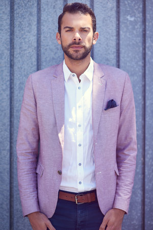 Being a gentleman never gets old. a well-dressed young man posing outside.の写真素材