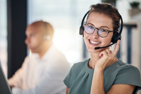 Call center, telemarketing and employee with smile for customer service, support and online help. Communication, consulting and portrait of a happy consultant in a crm office for business on the webの写真素材