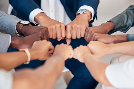 Hand, Fist or diversity business men and women teamwork together in mission, trust or goal in top...
