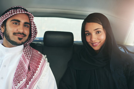 I chose the perfect partner to travel through life with. Portrait of a young arabic couple traveling in a luxury car.の写真素材