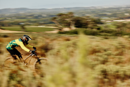 Mountain bike speed, race motion blur and extreme sports outdoor on dirt track in nature for competition. Bicycle man ride, cycling adventure and action danger and fast athlete to win contest in bushの写真素材
