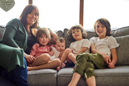 Were a big and blessed happy family. Portrait of a mother bonding with her four little children at home.の写真素材