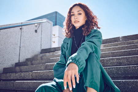 Fashion, travel and woman student on building steps in a city, with vision for mission, goal and...