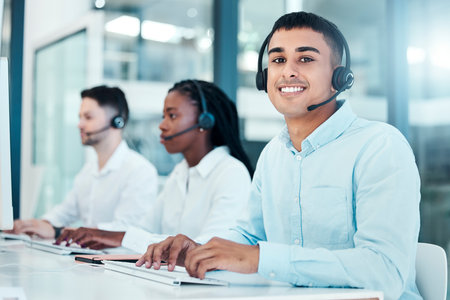 Call center, computer and typing email for contact us, CRM and customer service website in a diversity office with telemarketing team. Portrait of consultant man working in sales and supportの写真素材