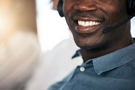 Customer support, black man and smile of a telemarketing worker on a call. Happy internet call center employee working on customer service, digital consultant work and contact us communicationの写真素材