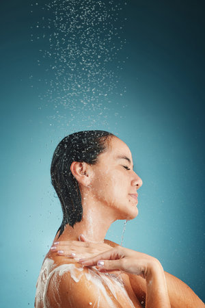 Shower, water splash and woman cleaning, hair and wellness, grooming and hair care in a studio with...