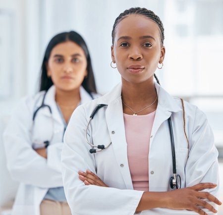 Healthcare, women and success, doctors with leadership mindset in hospital or clinic. Black woman doctor, medical partnership and teamwork with diversity, successful women boss and vision in medicineの写真素材