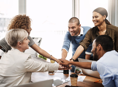 Weve got this. a group of businesspeople joining their hands together in unity.
