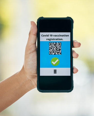 Hand, vaccination and qr code on app on a phone for registration for travel safety or protection. Covid vaccine, barcode and digital certificate on cellphone for healthcare compliance during pandemicの写真素材